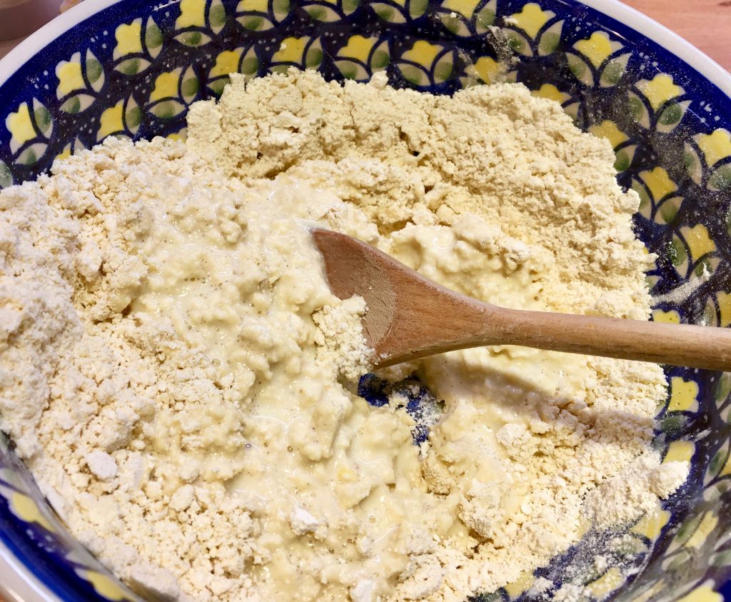 stir wet ingredients into dry with a wooden spoon in a Polish ceramic bowl