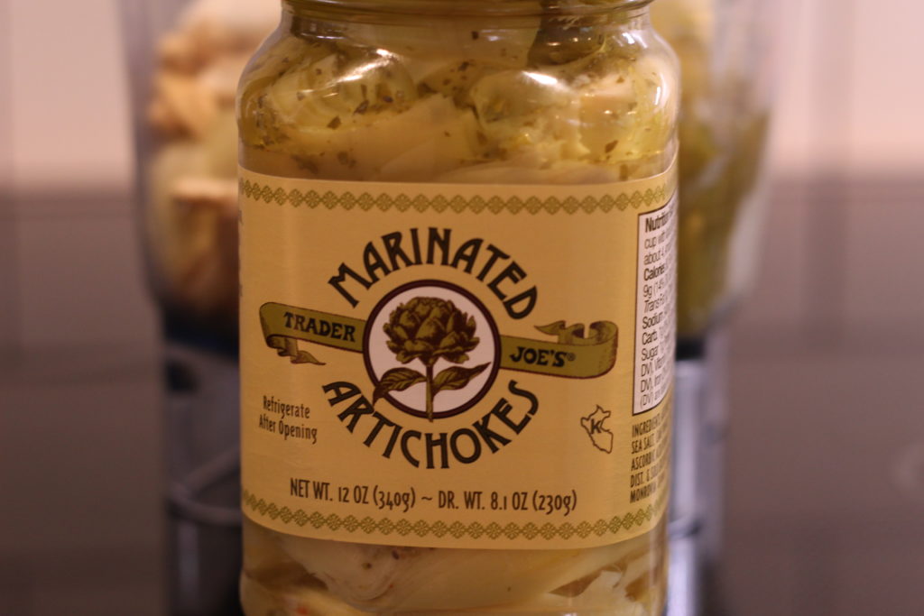 bottle of marinated artichokes on a counter