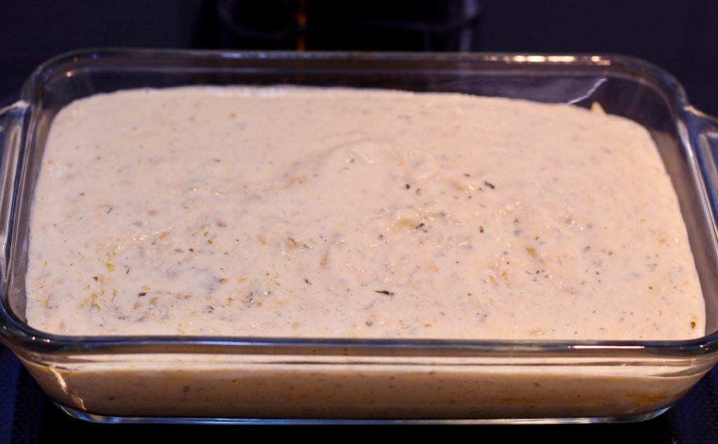 dairy-free artichoke dip in a glass pyrex baking dish