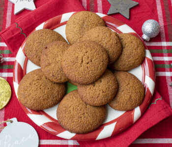 ginger cookies on a red and white plate on a red cloth